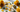 Healing crystals for abundance and prosperity including Citrine, Pyrite, Green Aventurine and Tigers Eye on a luxury background