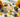 Healing crystals for abundance and prosperity including Citrine, Pyrite, Green Aventurine and Tigers Eye on a luxury background