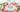 Blue Lace Agate hearts resting on ivory fabric, framed by soft pink roses.