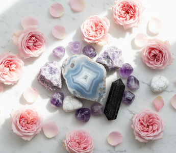 lue lace agate, lepidolite, amethyst, black tourmaline and howlite crystals on white marble with soft pink roses — calming crystals for anxiety and hyperarousal by Heavenly Crystals Online