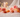 Carnelian, Sunstone and Rose Quartz crystals with pink roses and fairy lights for confidence and self-worth