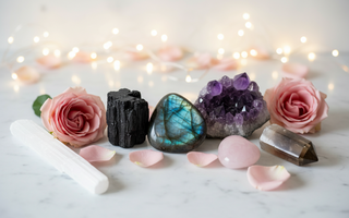 Healing crystals for empaths including Black Tourmaline, Labradorite and Amethyst with roses and fairy lights