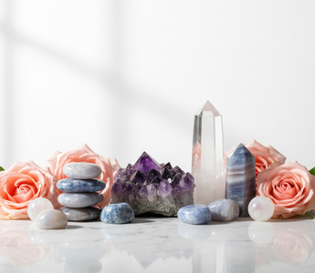 Amethyst, lepidolite, blue lace agate, clear quartz and moonstone crystals on white marble with soft pink roses — supportive crystals for sleep apnoea by Heavenly Crystals Online
