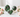Ruby Zoisite heart, sphere on a gold stand and polished freeform, with green and ruby-pink markings, surrounded by soft pink roses on white marble.