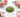Polished peridot crystal chips with soft pink roses on white marble
