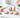 Peach Moonstone crystal shapes in soft peach and cream, arranged with pink roses on white marble.