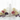 Selenite tower and wand with amethyst and white flowers on white marble surface