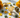 Healing crystals for abundance and prosperity including Citrine, Pyrite, Green Aventurine and Tigers Eye on a luxury background