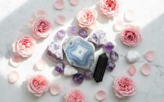 lue lace agate, lepidolite, amethyst, black tourmaline and howlite crystals on white marble with soft pink roses — calming crystals for anxiety and hyperarousal by Heavenly Crystals Online