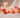 Carnelian, Sunstone and Rose Quartz crystals with pink roses and fairy lights for confidence and self-worth