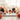 Citrine, sunstone, rose quartz, carnelian and black tourmaline crystals on white marble with soft pink roses — uplifting crystals for depression support by Heavenly Crystals Online