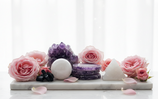 Amethyst, lepidolite, moonstone, black tourmaline and howlite crystals on white marble with soft pink roses — calming crystals for sleep disturbance and nightmares by Heavenly Crystals Online