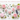 A soft dreamy editorial flat lay of spring equinox crystals including Rose Quartz sphere, heart, and tumbles, Moss Agate chips, and a Rainbow Fluorite point, styled with blush pink peonies, garden roses, and white cherry blossoms on white Carrara marble