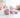 Pink Kunzite heart with natural crystals and soft pink roses, symbolising Heart and Crown Chakra connection.