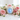 Glowing rainbow moonstone palm stone nestled among soft pink garden roses on white marble