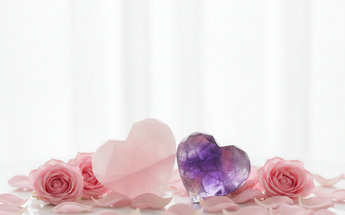 Rose quartz and amethyst crystal hearts with pink roses and fairy lights for healing, love and positive energy