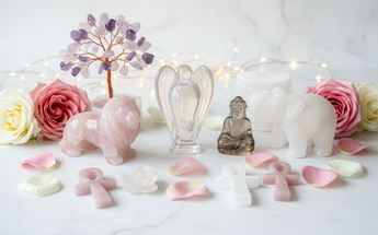 Hand-carved crystal angels, animals, Buddhas and crystal trees arranged with roses and fairy lights